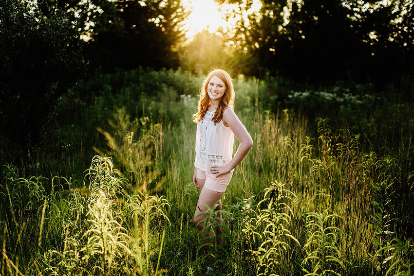 smiling in a sunlit grassy field