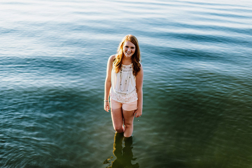 senior girl standing in a lake