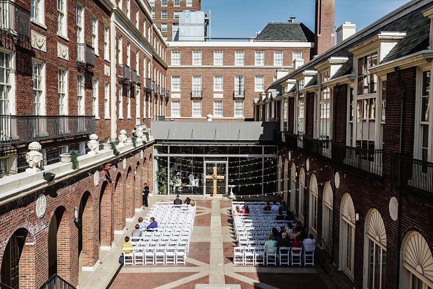 the wedding ceremony courtyard with guests arriving