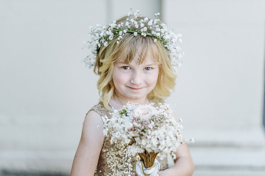 flower girl posing and smiling at the camera