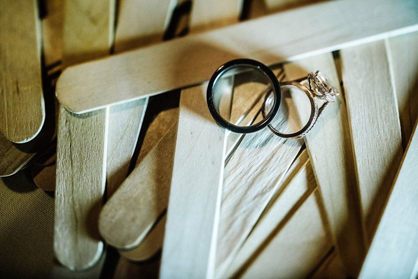 the wedding rings sitting on Popsicle sticks