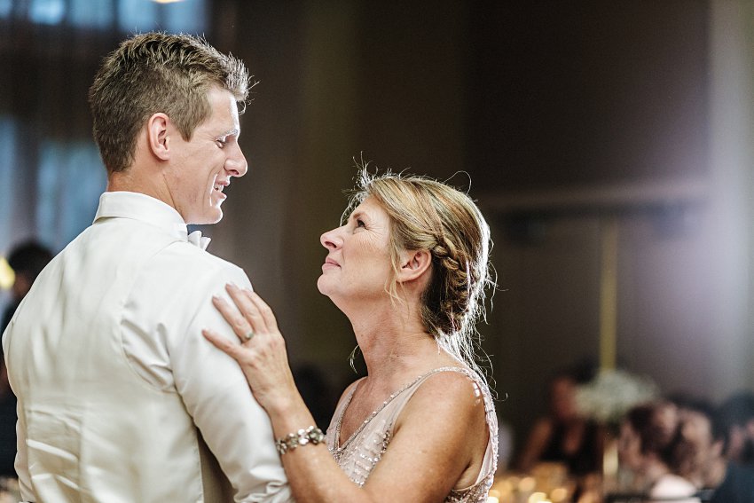 a groom dances with his mother