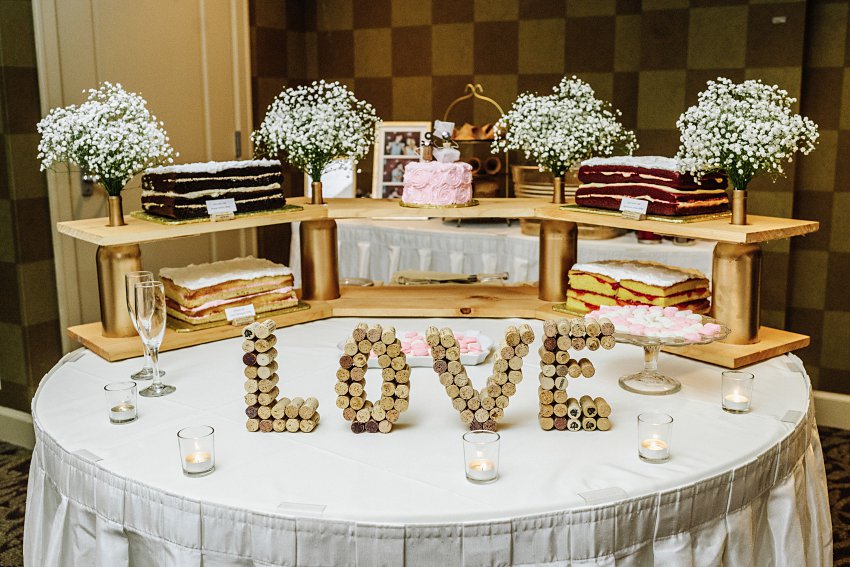 wedding cakes with the word love spelled out with wine corks