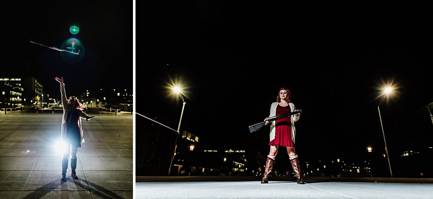 girl in a red dress at night twirling a rifle